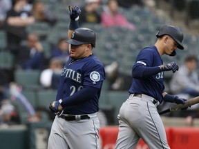 Left, Daniel Vogelbach #20 of the Seattle Mariners celebrates his solo home run during the ninth inning against the Chicago White Sox at Guaranteed Rate Field on April 07, 2019 in Chicago, Illinois.