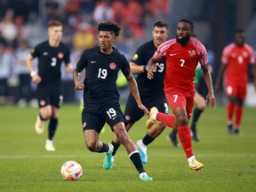 Charles Brym (19) of Canada is chased by Johan Rotsen (7) of Guadeloupe during the second half of a 2023 Concacaf Gold Cup match at BMO Field on June 27, 2023, in Toronto.