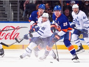 John Tavares of the Toronto Maple Leafs skates against Brock Nelson of the New York Islanders during the third period at UBS Arena on January 11, 2024 in Elmont, New York.
