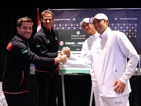 Alexis Galarneau, from left, and Vasek Pospisil of Canada and Jisung Nam and Minkyu Song of South Korea shake hands following the draw on Thursday for the Davis Cup match in Montreal.