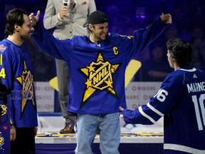 Singer Justin Bieber, middle, greets Mitch Marner, right, as Auston Matthews of the Toronto Maple Leafs looks on during 2024 NHL All-Star Thursday at Scotiabank Arena on Thursday, Feb. 1, 2024, in Toronto.