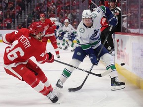 Brock Boeser (6) of the Vancouver Canucks tries to block a pass from Jeff Petry (46) of the Detroit Red Wings during the first period at Little Caesars Arena on Feb. 10, 2024 in Detroit, Michigan.