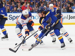 Evander Kane #91 of the Edmonton Oilers defends against Kasperi Kapanen #42 of the St. Louis Blues during the first period at Enterprise Center on February 15, 2024 in St Louis, Missouri.