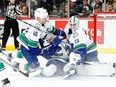 Elias Pettersson #40 and Filip Hronek #17 collide with Casey DeSmith #29 of the Vancouver Canucks against the Minnesota Wild in the second period at Xcel Energy Center on February 19, 2024 in St Paul, Minnesota.