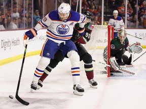 Edmonton Oilers forward Leon Draisaitl of the Edmonton Oilers controls the puck under pressure Arizona Coyotes defenceman J.J. Moser during the first period of Monday afternoon's game at Mullett Arena in Tempe Arizona.