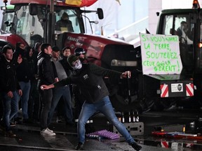 A protester prepares to throw an egg during a protest called by the farmers' organizations "Federation Unie de Groupements d'Eleveurs et d'Agriculteurs" (FUGEA), Boerenforum and MAP, in response to the European Agriculture Council, in Brussels, on February 26, 2024.