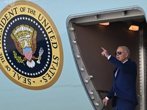 US President Joe Biden gestures as he arrives at John F. Kennedy International Airport, in Queens, New York on February 26, 2024. Biden is in New York to attend a campaign event.