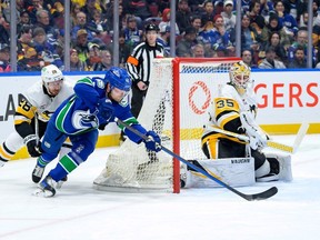 Canucks centre Elias Pettersson attempts a wrap-around goal against the Penguins on Tuesday at Rogers Arena.