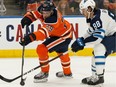 Edmonton Oilers' Leon Draisaitl (29) battles Winnipeg Jets' Nathan Beaulieu (88) during first period NHL hockey action at Rogers Place in Edmonton on Feb. 29, 2020.