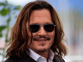 Johnny Depp poses during a photocall for the film "Jeanne Du Barry" during the 76th edition of the Cannes Film Festival in Cannes, southern France, on May 17, 2023.