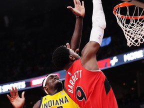 Toronto Raptors guard RJ Barrett (9) scores past Indiana Pacers forward Pascal Siakam (43) during first half NBA basketball action in Toronto on Wednesday, February 14, 2024. THE CANADIAN PRESS/Chris Young