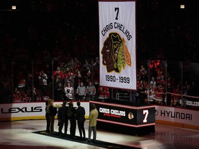 Former Chicago Blackhawks player Chris Chelios and his family watch as his number is lifted to the rafters during a jersey retirement celebration at the United Center on February 25, 2024 in Chicago.