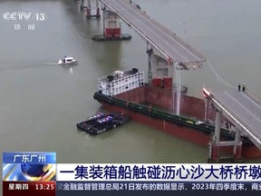 In this image from video released by China's CCTV, people inspect the broken Lixinsha Bridge after being hit by a container ship in Nansha District of Guangzhou, south China's Guangdong Province, Thursday, Feb. 22, 2024.