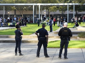 Houston Police officers watch over displaced churchgoers outside Lakewood Church, Sunday, Feb. 11, 2024, in Houston.