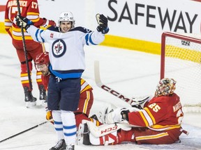 Winnipeg Jets center Sean Monahan celebrates a goal on Calgary Flames goaltender Jacob Markstrom in the first period at the Saddledome on Monday, February 19, 2024. Brent Calver/Postmedia
