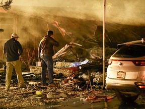 Investigators look at the burned out remains of a mobile home after a plane crash Thursday, Feb. 1, 2024 in Clearwater, Fla.