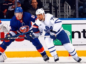 Ryan Reaves, right, of the Toronto Maple Leafs skates against the New York Islanders.