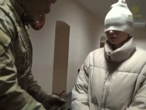 Ksenia Karelina, an American citizen, is seen under arrest in Russia.