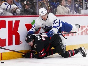 Maple Leafs left wing Matthew Knies (23) checks Senators defenceman Thomas Chabot (72) to the ice during first period NHL action in Ottawa, Saturday, Feb. 10, 2024.