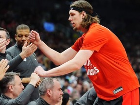 Toronto Raptors' Kelly Olynyk greets his team's bench during warm-up prior to NBA action against the Houston Rockets in Toronto on Friday. Frank Gunn/The Canadian Press