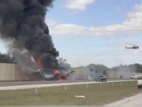 Smoke and fire fills the air after an airplane crashed on Interstate 75, Friday, Feb. 10, 2024 near Naples, Fla.