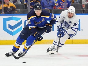 Auston Matthews of the Toronto Maple Leafs chases Colton Parayko of the St. Louis Blues in the second period at Enterprise Center on Feb. 19, 2024 in St Louis, Missouri.