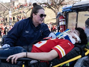 An injured person is aided near the Kansas City Chiefs' Super Bowl LVIII victory parade on February 14, 2024 in Kansas City, Missouri.