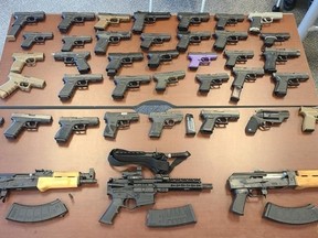 Some of the weapons seized during Project SAXOM, a cross-border operation that netted 274 illegal firearms and a large quantity of drugs that was announced by police on Thursday, Feb. 22, 2024, in Orillia, Ont.