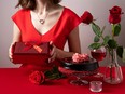 Valentine's Day dinner with table place setting with red wine, candles and chocolate cake.