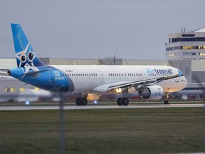 An Air Transat Airbus A321 jet rolls down the runway on takeoff from Montreal's Trudeau Airport Wednesday Nov. 17, 2021.