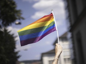 A person holds a Pride flag during the Zurich Pride parade in Zurich, Switzerland, Saturday, June 17, 2023.