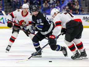 Lightning’s Nikita Kucherov skates past Senators’ Brady Tkachuk in Tampa last night.