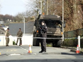 Police and bomb disposal experts stand at the scene near St Michael Avenue, where residents have been evacuated and a cordon put in place following the discovery of a suspected Second World War explosive device, in Plymouth, England, Friday Feb. 23, 2024.