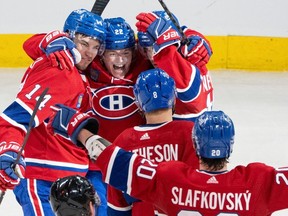 Canadiens' Nick Suzuki (14) celebrates his second goal Tuesday night with teammates Cole Caufield (22), Mike Matheson (8), Alex Newhook (15) and Juraj Slafkovsky at teh Bell Centre.