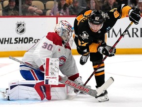 Pittsburgh Penguins' Rickard Rakell (67) trips over the stick of Montreal Canadiens goaltender Cayden Primeau during the second period of an NHL hockey game in Pittsburgh, Thursday, Feb. 22, 2024.