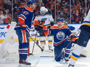 Connor McDavid (97) and Zach Hyman (18) of the Edmonton Oilers, celebrate a first period goal against the St. Louis Blues at Rogers Place in Edmonton on Feb. 28, 2024.