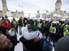Police move in to clear downtown Ottawa near Parliament hill of protesters after weeks of demonstrations on Saturday, Feb. 19, 2022.