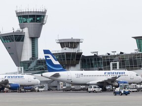 Aircraft operated by Finnair are prepared for flight by ground staff at Helsinki-Vantaa airport in Helsinki, Finland, on Wednesday, April 11, 2012.