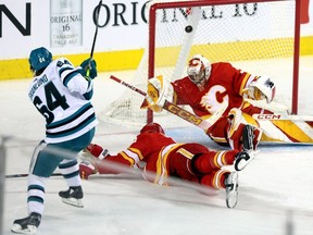 Calgary Flames goalie Dustin Wolf is scored on by San Jose Sharks forward Mikael Granlund at the Scotiabank Saddledome in Calgary on Thursday, Feb. 15, 2024.