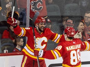 Calgary Flames defenceman Oliver Kylington celebrates his goal against the Winnipeg Jets wtih Andrew Mangiapane at the Saddledome in Calgary on Monday, Feb. 19, 2024.