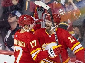 Calgary Flames forward Jonathan Huberdeau (10) celebrates a goal on the Winnipeg Jets, bringing the Flames up 4-3, in the second period at the Saddledome on Monday, February 19, 2024.