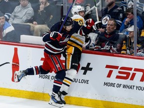 Winnipeg Jets' Vladislav Namestnikov (7) and Pittsburgh Penguins' Lars Eller (20) collide during second period NHL action in Winnipeg on Saturday, Feb. 10, 2024.