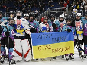 One year after a group of Ukrainian preteen hockey players took the Quebec International Peewee Hockey Tournament by storm, a new group of kids are expected to arrive in the province at the end of the week. Vermont Flames Academy and Ukraine team Selects peewee team stand together at the end of a game in Quebec City, Friday, February 17, 2023.