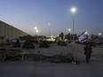 Israeli activists set up tents for blocking trucks carrying humanitarian aid into the Gaza Strip at the Kerem Shalom border crossing between Israel and Gaza, in southern Israel, Wednesday, Feb. 7, 2024. The activists say no aid should enter the territory until Israeli hostages held captive by the Hamas militant group are released.