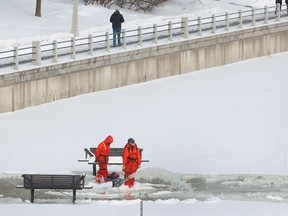 NCC crews flood the ice near the Flora Footbridge on the Rideau Canal in Ottawa Friday.