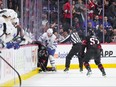 Morgan Rielly of the Toronto Maple Leafs stands over Ridly Greig of the Ottawa Senators after being cross checked in the head following his empty net goal at Canadian Tire Centre on Feb. 10, 2024 in Ottawa.