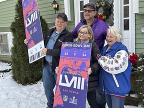 Don Crisman, far left, poses with his wife, Beverley, far right, his daughter Sue Metevier, and her partner Charles Hugo, with posters of Super Bowl 58 tickets, Thursday Jan. 18, 2024, in Kennebunk, Maine. Don Crisman is one of the very few people who has attended every Super Bowl.