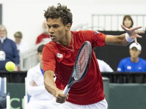Gabriel Diallo, of Canada, hits a return to Soonwoo Kwon, of South Korea, during the first singles match of the Davis Cup tennis qualifiers in Montreal, Friday, Feb. 2, 2024.