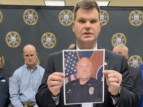 In this image made from video shown in the Blount County Sheriff's Office's Facebook page, an official shows a picture of Deputy Greg McCowan in Maryville, Tenn., Friday, Feb. 9, 2024.