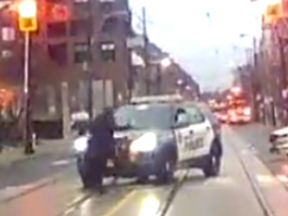 Rachel Wharton has a close encounter with a Toronto Police vehicle in a screenshot from video supplied to the Sun.